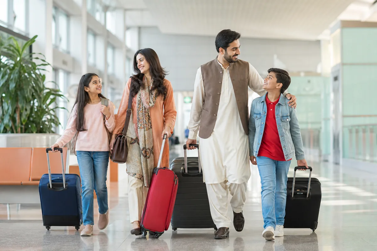 Family arriving at an airport terminal for a holiday in Dubai