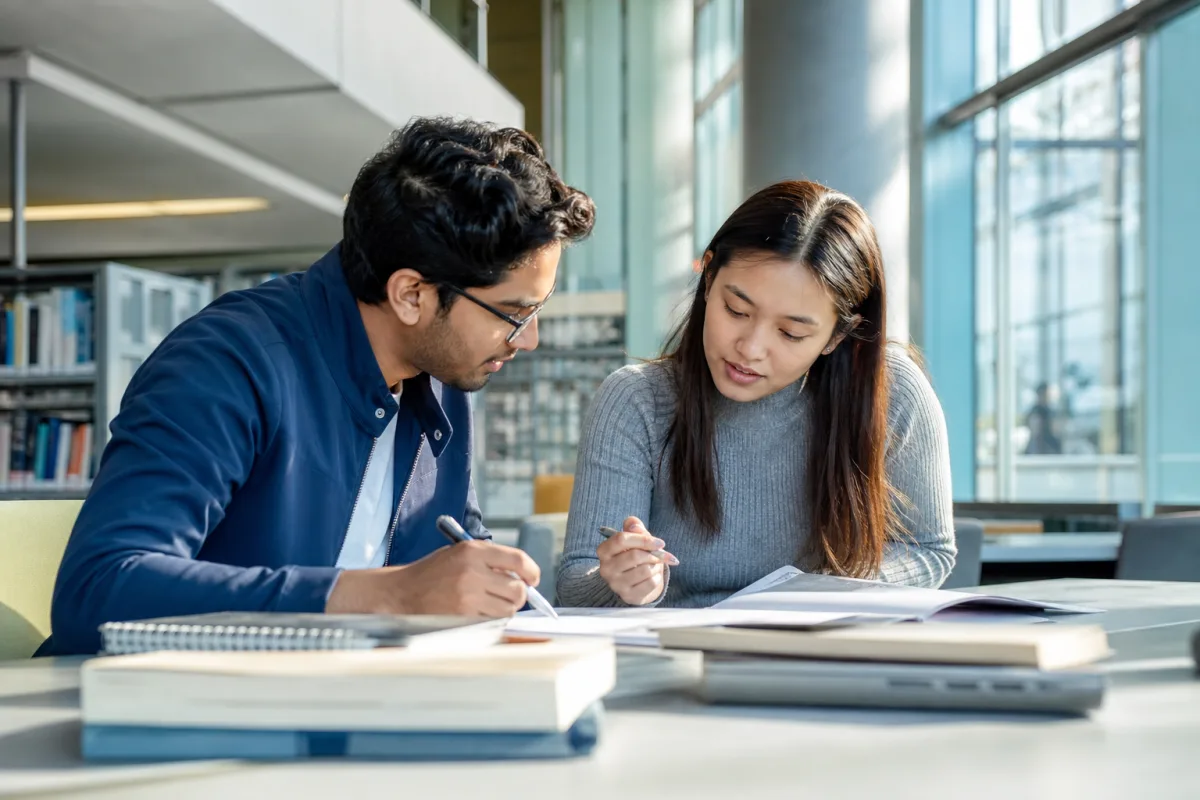 Students studying together in a modern German university library